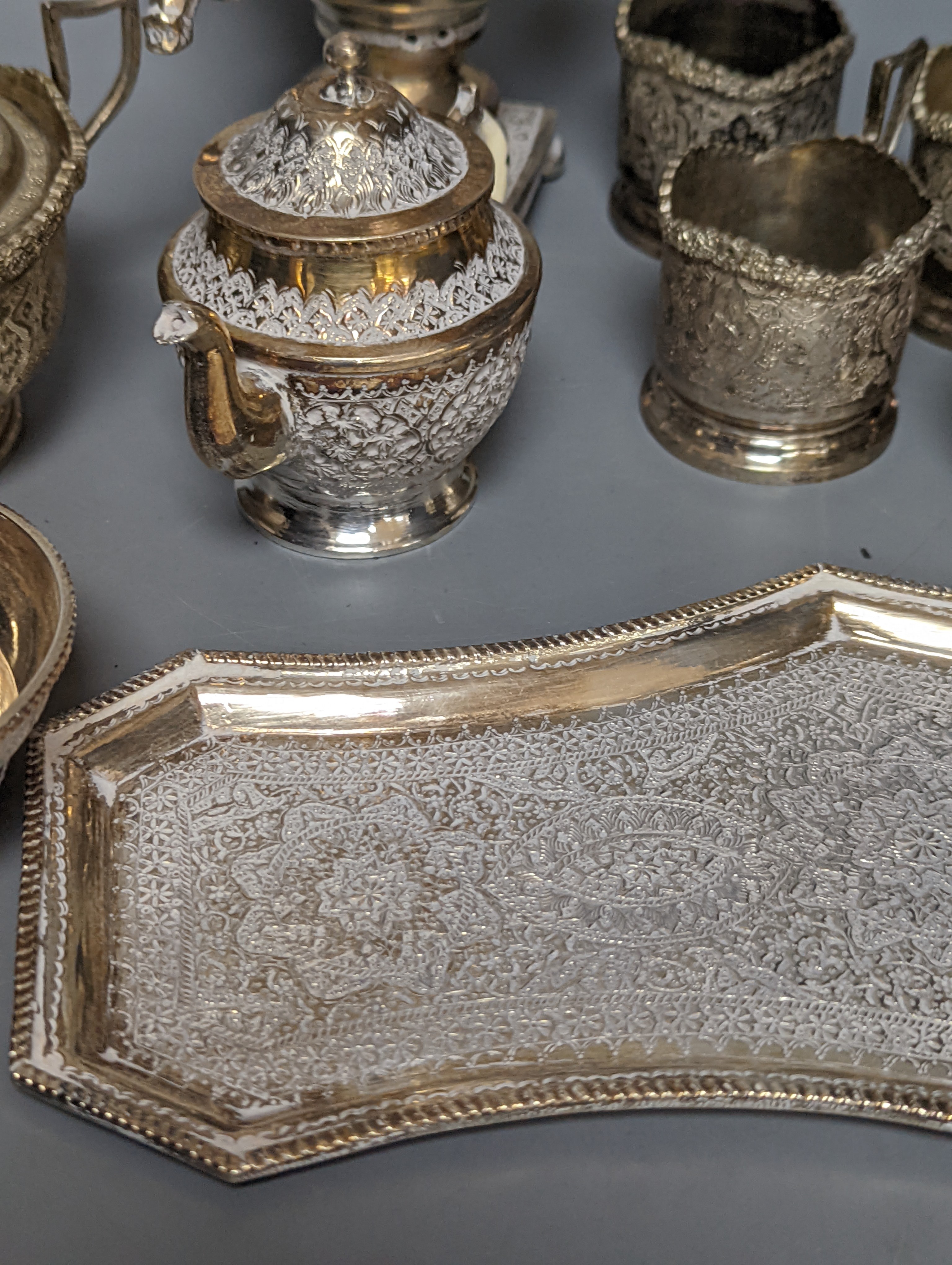 A set of six Persian embossed 84 standard white metal coffee cup holders and matching sugar bowl and cover by Vartan and four other Persian white metal items.